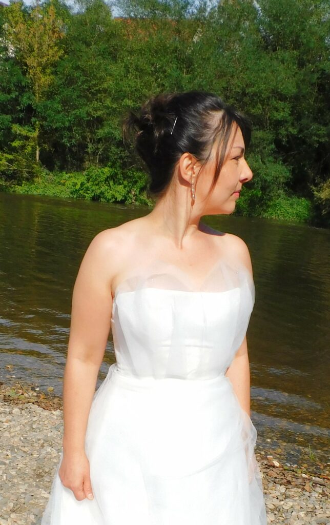 Les Précieuses- Robe de mariée Angelite vue de face proche. Bustier recouvert de tulle et tulle pailleté. Bas avec épaisseurs de tulle et un drapé de tulle pailleté.